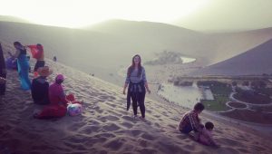 Standing on the sand dunes near an oasis in the Gobi Desert
